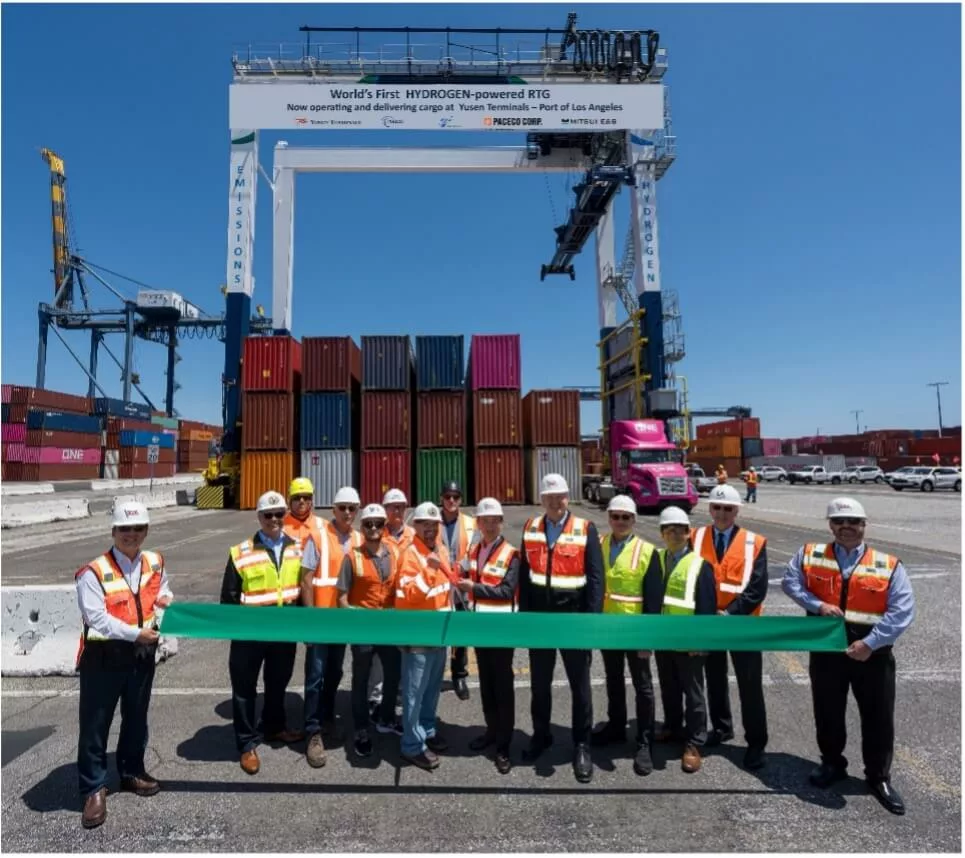 Green ribbon cutting for the world's first zero-emission, hydrogen-powered rubber-tired gantry (RTG) at Yusen Terminals operating in the Port of Los Angeles, May 7, 2024. Gary Herrera, President, ILWU Local 13 (center left), Hiroki Tsujii, Managing Director Ocean Network Express Pte. Ltd. (center), Alan McCorkle, President & CEO, Yusen Terminals (center right).
Photo: Chris Valle/Yusen Terminals
