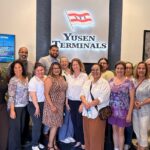 Members of the San Pedro Chamber of Commerce posing for a group photo during a tour at the Yusen Terminals lobby.